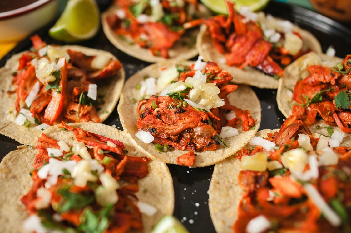 Fresh Mexican tacos al pastor with lemon and sauce in Mexico